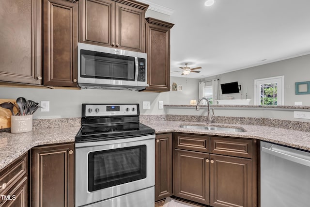 115 Creech Place Dr, Benson, NC 27504 - kitchen with appliances with stainless steel finishes, ceiling fan, dark brown cabinets, light stone counters, and crown molding