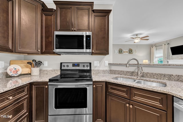 115 Creech Place Dr, Benson, NC 27504 - kitchen featuring stainless steel appliances, dark brown cabinets, a ceiling fan, light stone countertops, and crown molding