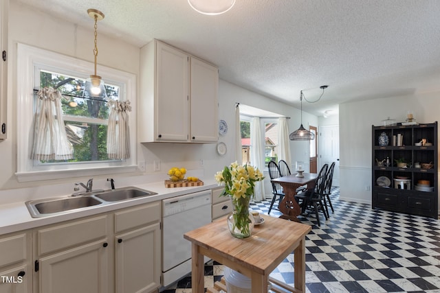 107 Leighton Pl, Knightdale, NC 27545 - kitchen with white dishwasher, tile patterned floors, light countertops, decorative light fixtures, and white cabinetry