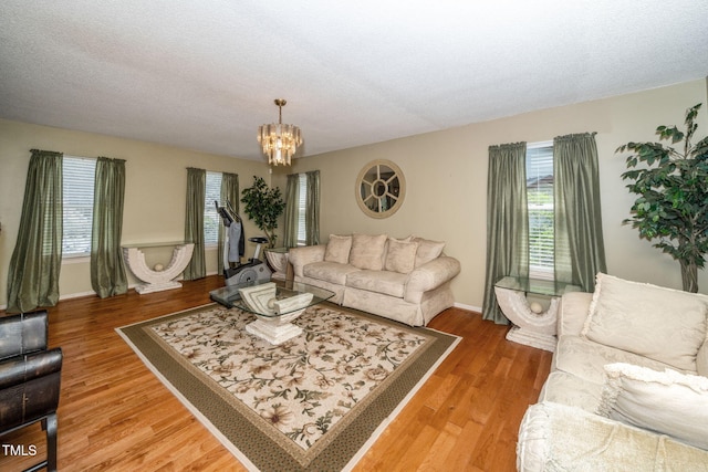 501 Dandelion Ct, Raleigh, NC 27610 - living area featuring a chandelier, light wood-type flooring, and a textured ceiling