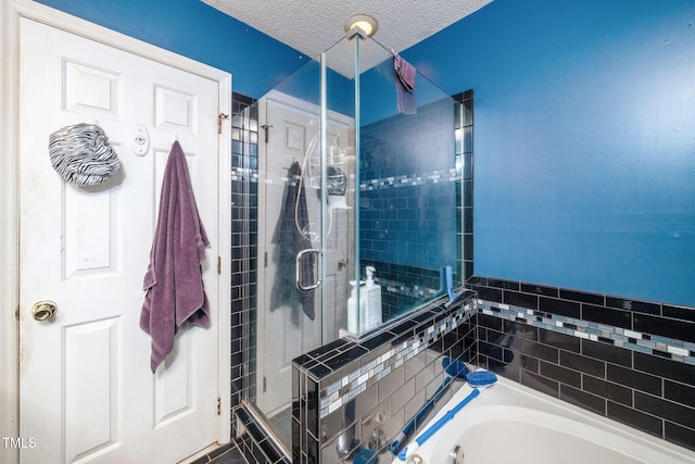 501 Dandelion Ct, Raleigh, NC 27610 - full bath featuring a stall shower, a garden tub, and a textured ceiling
