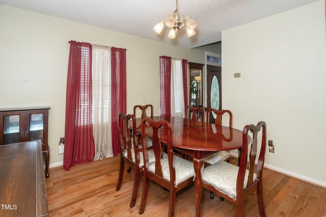 501 Dandelion Ct, Raleigh, NC 27610 - dining space featuring a chandelier and light wood finished floors