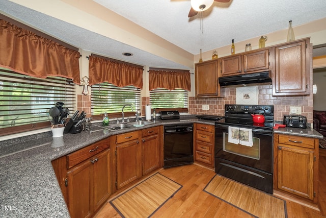 501 Dandelion Ct, Raleigh, NC 27610 - kitchen featuring black appliances, under cabinet range hood, ceiling fan, light wood-style flooring, and brown cabinets