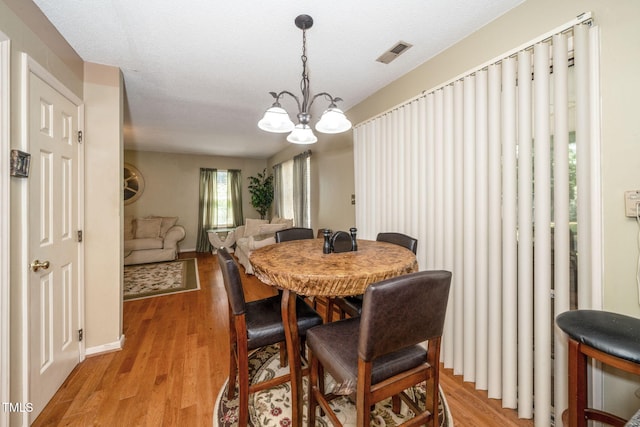 501 Dandelion Ct, Raleigh, NC 27610 - dining room with a chandelier and light wood-type flooring