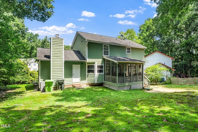 501 Dandelion Ct, Raleigh, NC 27610 - back of house featuring a sunroom, a chimney, roof with shingles, and entry steps