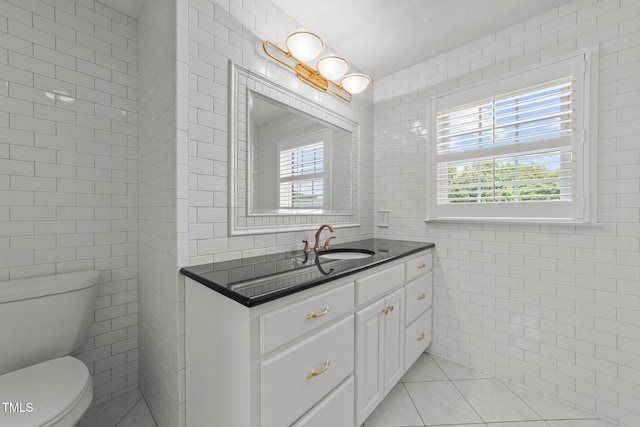 7390 NC-50, Angier, NC 27501 - bathroom featuring tile walls, healthy amount of natural light, vanity, and tile patterned floors