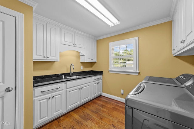 7390 NC-50, Angier, NC 27501 - washroom with separate washer and dryer, cabinet space, crown molding, and light wood-style flooring
