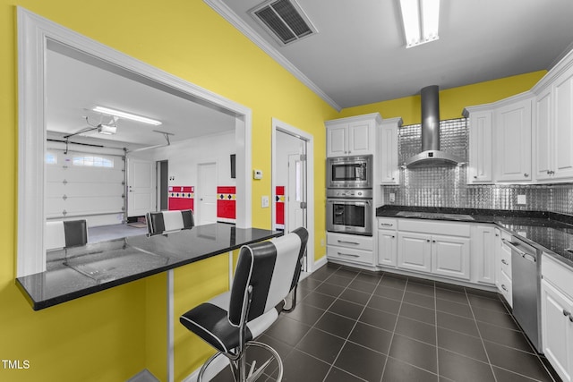 7390 NC-50, Angier, NC 27501 - kitchen with stainless steel appliances, wall chimney exhaust hood, white cabinets, tasteful backsplash, and a breakfast bar area