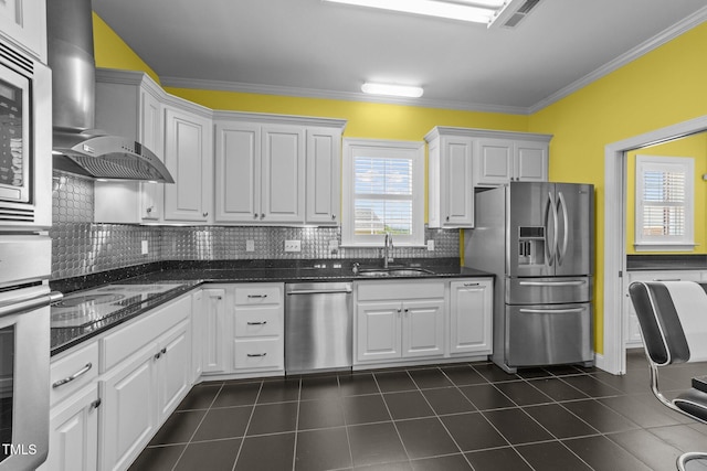 7390 NC-50, Angier, NC 27501 - kitchen with appliances with stainless steel finishes, crown molding, tasteful backsplash, wall chimney exhaust hood, and white cabinets