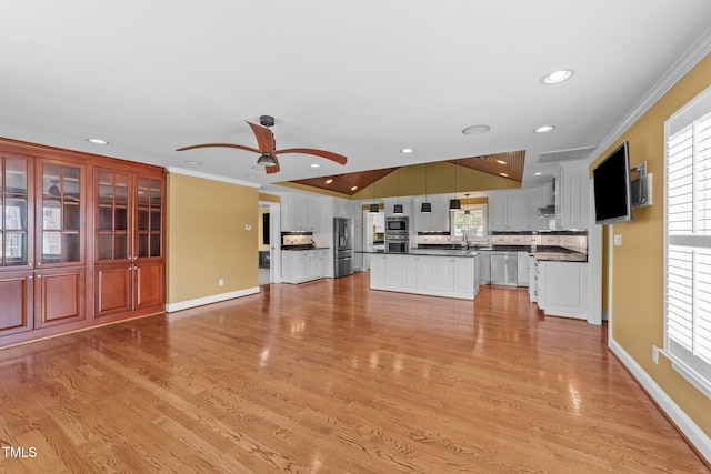 7390 NC-50, Angier, NC 27501 - unfurnished living room featuring a ceiling fan, crown molding, plenty of natural light, light wood-type flooring, and recessed lighting