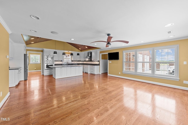 7390 NC-50, Angier, NC 27501 - unfurnished living room featuring ornamental molding, plenty of natural light, a ceiling fan, light wood-type flooring, and recessed lighting