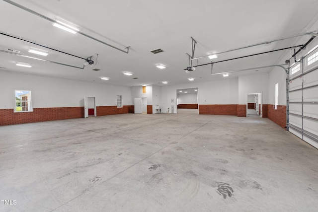 7390 NC-50, Angier, NC 27501 - garage featuring a wainscoted wall and a garage door opener
