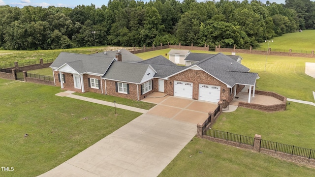 7390 NC-50, Angier, NC 27501 - view of front of home with brick siding, an attached garage, driveway, and roof with shingles