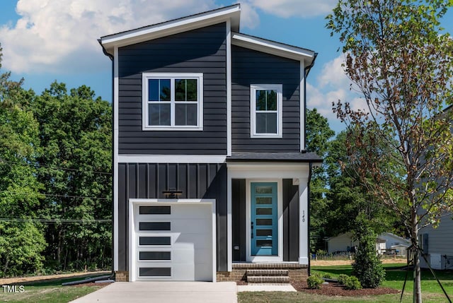 140 E End Ave, Durham, NC 27703 - contemporary house featuring board and batten siding, an attached garage, driveway, and a front lawn