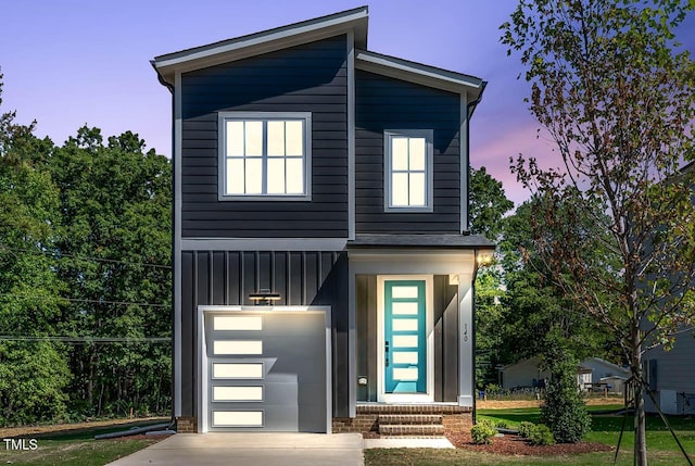 140 E End Ave, Durham, NC 27703 - contemporary house featuring board and batten siding, a garage, and concrete driveway