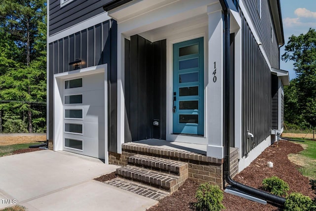 140 E End Ave, Durham, NC 27703 - property entrance featuring board and batten siding, a garage, and driveway