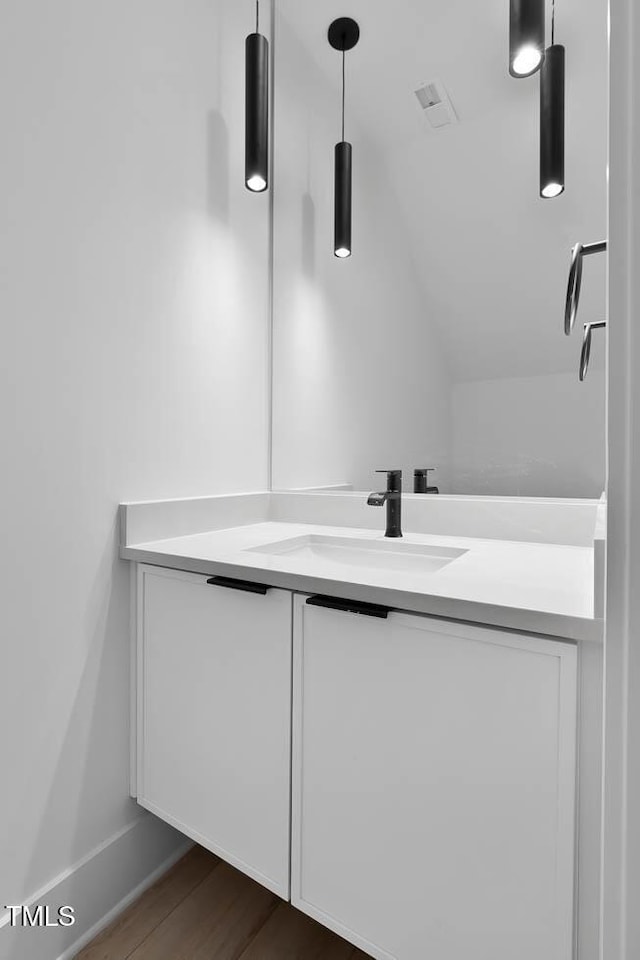 140 E End Ave, Durham, NC 27703 - bathroom featuring vanity, wood finished floors, and vaulted ceiling