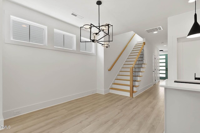 140 E End Ave, Durham, NC 27703 - stairway with wood finished floors, a chandelier, and recessed lighting