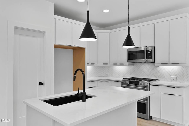 140 E End Ave, Durham, NC 27703 - kitchen featuring appliances with stainless steel finishes, white cabinetry, backsplash, hanging light fixtures, and light countertops