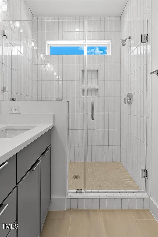140 E End Ave, Durham, NC 27703 - bathroom featuring tile patterned floors, a stall shower, vanity, and plenty of natural light
