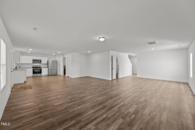 9059 Shallow Creek Trl, Bailey, NC 27807 - unfurnished living room with recessed lighting and dark wood-type flooring
