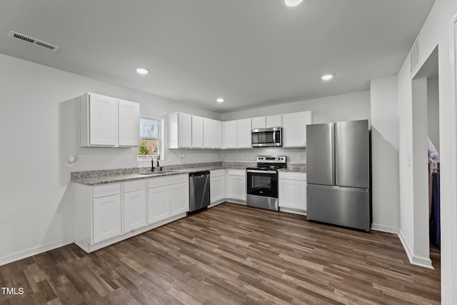 9059 Shallow Creek Trl, Bailey, NC 27807 - kitchen featuring stainless steel appliances, white cabinetry, dark wood-type flooring, light stone counters, and recessed lighting