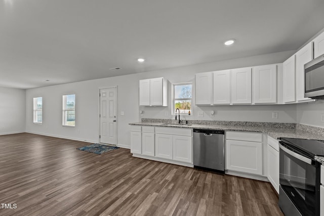 9059 Shallow Creek Trl, Bailey, NC 27807 - kitchen with appliances with stainless steel finishes, recessed lighting, dark wood-style flooring, plenty of natural light, and white cabinets