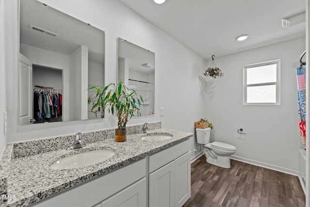 9059 Shallow Creek Trl, Bailey, NC 27807 - full bathroom with double vanity, wood finished floors, shower / bath combo, and recessed lighting