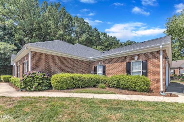 4710 Ludwell Branch Ct, Raleigh, NC 27612 - view of front facade with brick siding, roof with shingles, and a front lawn