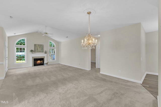 4710 Ludwell Branch Ct, Raleigh, NC 27612 - unfurnished living room with ceiling fan, carpet flooring, a chandelier, vaulted ceiling, and a fireplace with flush hearth
