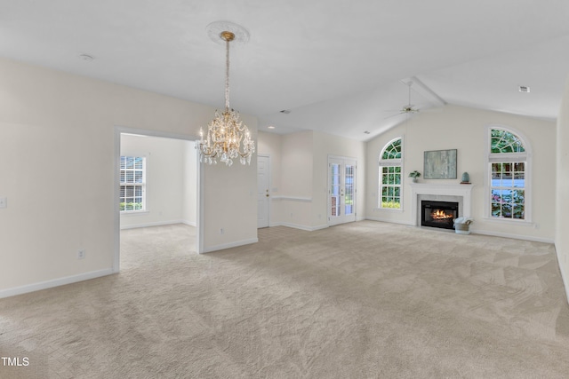 4710 Ludwell Branch Ct, Raleigh, NC 27612 - unfurnished living room featuring carpet, ceiling fan, a chandelier, vaulted ceiling, and a high end fireplace