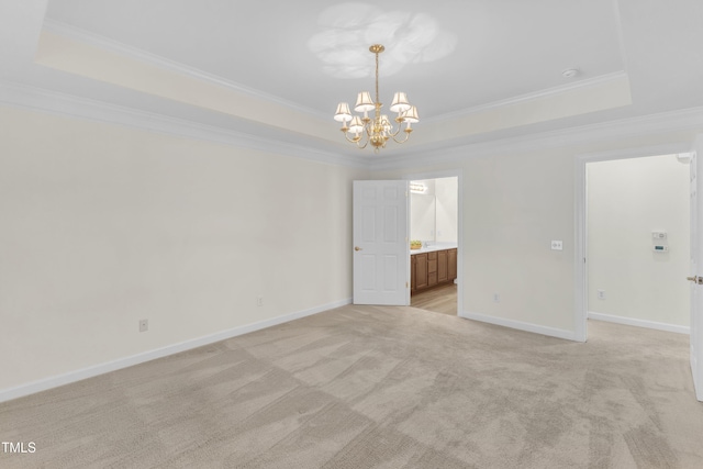 4710 Ludwell Branch Ct, Raleigh, NC 27612 - spare room with a raised ceiling, ornamental molding, a chandelier, and light carpet