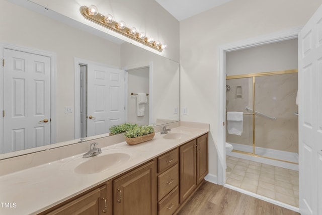 4710 Ludwell Branch Ct, Raleigh, NC 27612 - full bathroom featuring double vanity, a marble finish shower, and wood finished floors