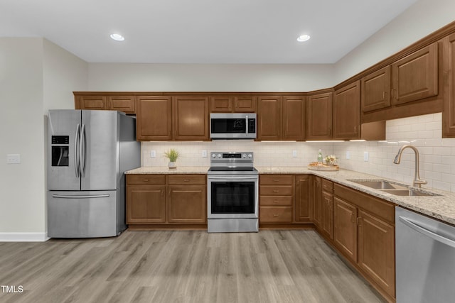 4710 Ludwell Branch Ct, Raleigh, NC 27612 - kitchen featuring stainless steel appliances, light wood finished floors, light stone counters, backsplash, and recessed lighting