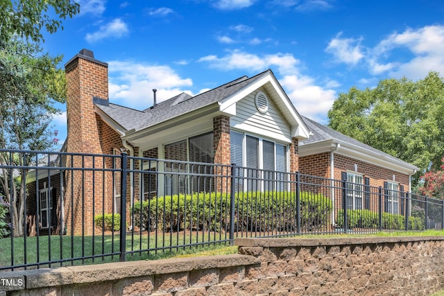 4710 Ludwell Branch Ct, Raleigh, NC 27612 - view of side of home with brick siding, a chimney, and a shingled roof