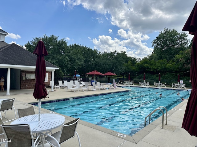 4710 Ludwell Branch Ct, Raleigh, NC 27612 - community pool featuring a patio and view of scattered trees