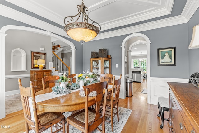 2512 Stewart St, Fuquay Varina, NC 27526 - dining space featuring ornate columns, arched walkways, ornamental molding, light wood-style floors, and stairs