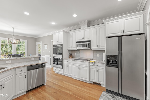 2512 Stewart St, Fuquay Varina, NC 27526 - kitchen featuring stainless steel appliances, white cabinets, light wood finished floors, ornamental molding, and recessed lighting