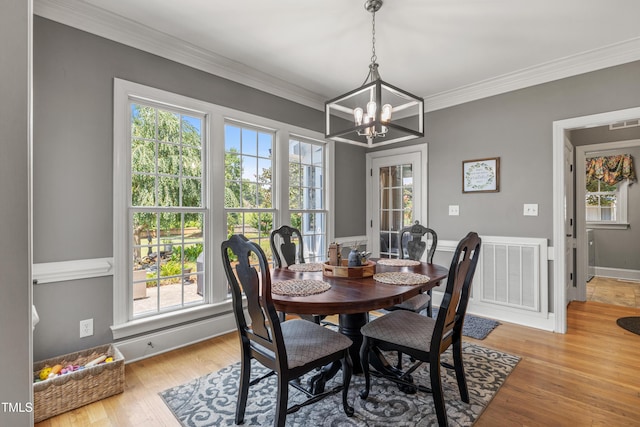 2512 Stewart St, Fuquay Varina, NC 27526 - dining room featuring a chandelier, healthy amount of natural light, light wood-style floors, and ornamental molding