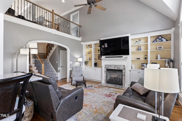 2512 Stewart St, Fuquay Varina, NC 27526 - living room with ceiling fan, high vaulted ceiling, stairs, a fireplace with flush hearth, and light wood-style floors