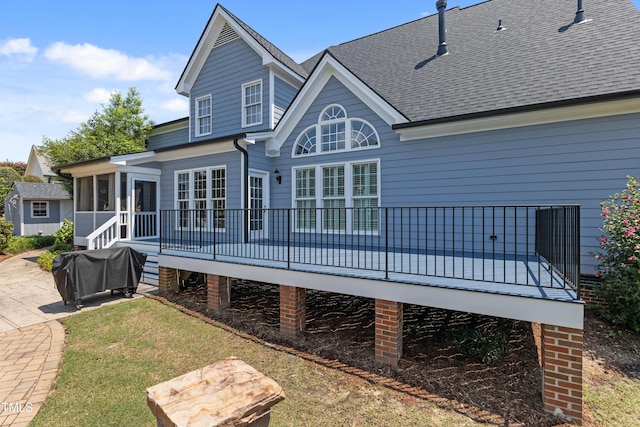 2512 Stewart St, Fuquay Varina, NC 27526 - back of house with a sunroom, a deck, a shingled roof, and a lawn