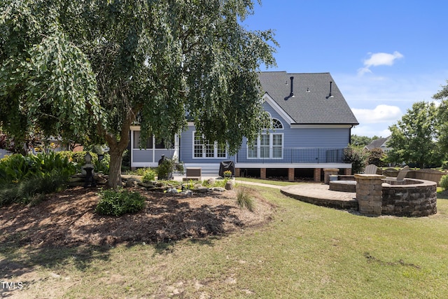 2512 Stewart St, Fuquay Varina, NC 27526 - back of property featuring an outdoor fire pit, a lawn, and roof with shingles