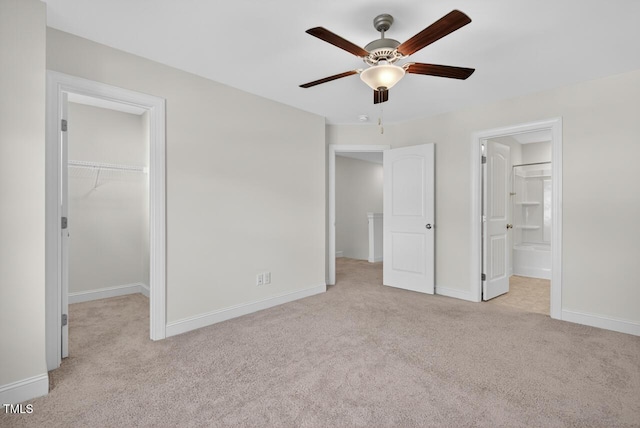 305 Lionel St, Durham, NC 27705 - unfurnished bedroom featuring carpet floors, a spacious closet, a closet, connected bathroom, and a ceiling fan