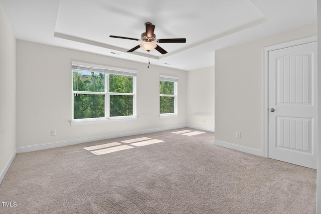 305 Lionel St, Durham, NC 27705 - carpeted empty room with a raised ceiling and ceiling fan