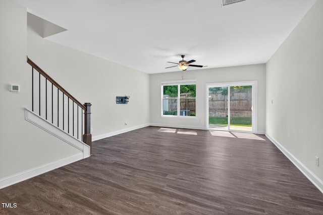 305 Lionel St, Durham, NC 27705 - unfurnished living room with a ceiling fan, dark wood-style flooring, and stairway