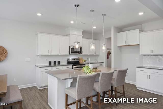 283 Old Fashioned Way, Lillington, NC 27546 - kitchen with stainless steel appliances, backsplash, dark wood-style flooring, white cabinets, and a center island with sink