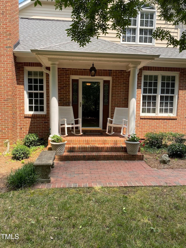 3802 Burwell Rollins Cir, Raleigh, NC 27612 - property entrance with brick siding, covered porch, and a shingled roof