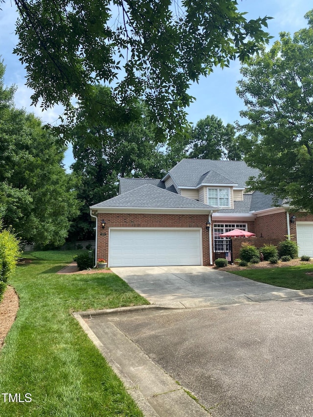 3802 Burwell Rollins Cir, Raleigh, NC 27612 - traditional-style home featuring brick siding, concrete driveway, a garage, a front lawn, and roof with shingles