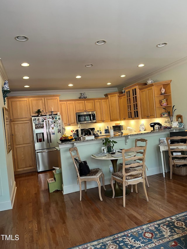 3802 Burwell Rollins Cir, Raleigh, NC 27612 - kitchen featuring appliances with stainless steel finishes, crown molding, glass insert cabinets, a kitchen breakfast bar, and recessed lighting