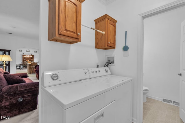9633 Grassy Creek Rd, Bullock, NC 27507 - laundry room with washing machine and dryer, cabinet space, and ornamental molding